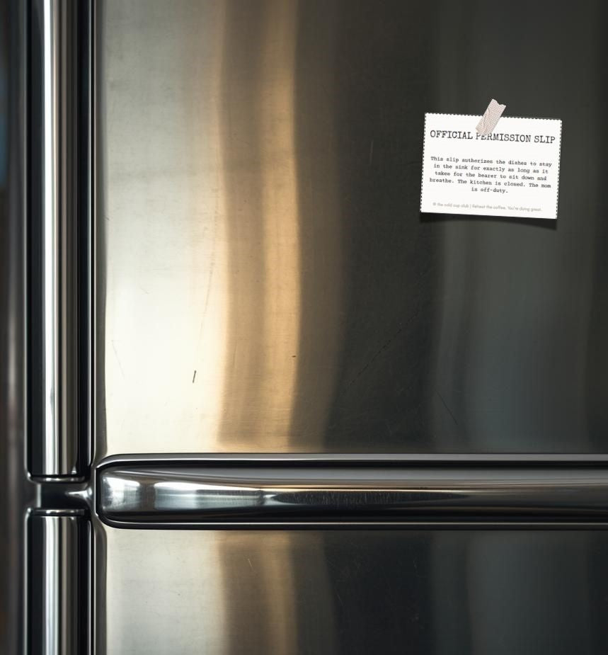 Stainless steel refrigerator with a paper note attached to the door.